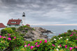 Portland Head Light at summer cloudy day and flowers in Maine, New England.