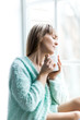 © Inna Vlasova - To warm yourself in the cool morning. portrait of a young woman by the window