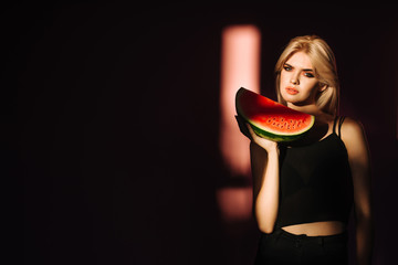 portrait happy young woman is holding slice of watermelon. Taste of watermelon. Summer. Fruits.