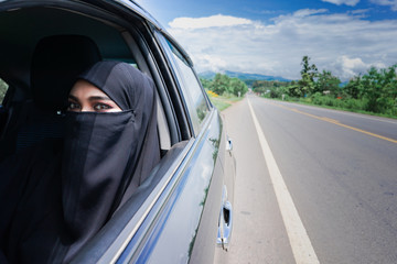 Wall Mural - Saudi Woman Driving a Car on the road. Muslim Woman Driver concept