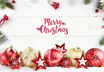 Poster - Greeting Festive Christmas composition of golden balls and red stars on white wooden boards in frame fir branches, gifts with with an inscription Merry Christmas!