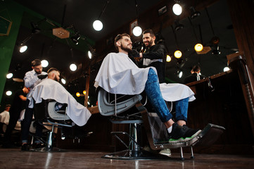 Wall Mural - Handsome bearded man at the barbershop, barber at work.