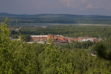 old mining buildings in green forest