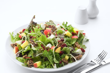 Wall Mural - close up view of fresh vegetable salad on white background