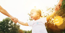 Little 2 Years Old Girl Walking With Parents Holding Their Hands Bright Summer Image