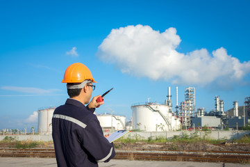 Wall Mural - Engineer working in the oil refinery with talking controlling work