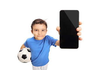 Wall Mural - Little footballer showing a cell phone