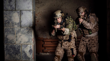 soldiers or private military contractors holding rifle. Image on a black background. war, army, weapon, technology and people concept