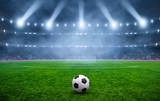 Fototapeta Sport - Ball on gras in soccer stadium