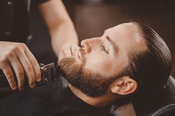 Wall Mural - Man hipster having barber shave barbershop hair machine.