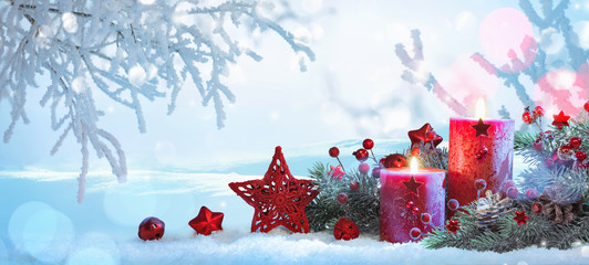 Wall Mural - christmas decorations with candles on a snowy background
