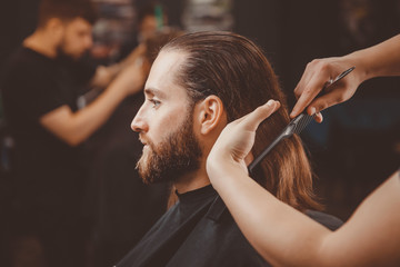 Wall Mural - Barber shop. Man in barbershop chair, hairdresser styling his hair