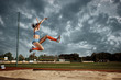 © master1305 - Female athlete performing a long jump during a competition at stadium. The jump, athlete, action, motion, sport, success, championship concept