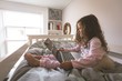 © Wavebreak Media - Girl using laptop on bed in bedroom