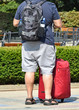 © majorosl66 - Man is standing on the street with luggage