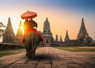 Tourists With an Elephant at Wat Chaiwatthanaram temple in Ayutthaya Historical Park, a UNESCO world heritage site in Thailand