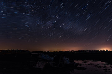 Old car in field on a starry night