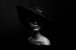 © Екатерина Переславце - portrait of a woman in a black hat on a black background black and white photo