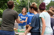 Volunteers serving food for poor people outdoors