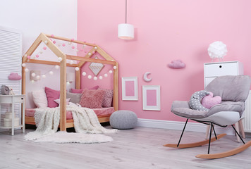 Poster - child's room interior with comfortable bed and garland