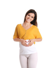 Wall Mural - Happy pregnant woman posing on white background