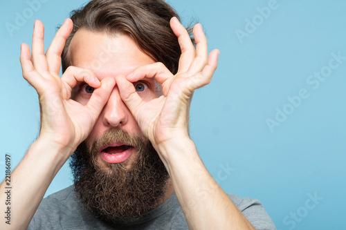 funny ludicrous joyful comic playful man pretending to look through binoculars made of hands Poster Mural XXL