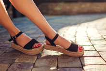 Stylish Woman Wearing Black Summer Shoes With Straw Sole Outdoors. Comfortable Sandals. Beauty Fashion.