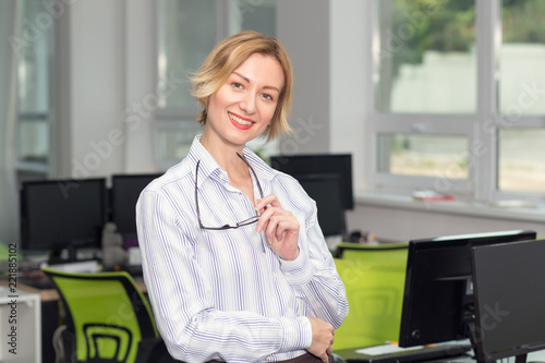 Fotografie, Obraz Smiling business woman. Portrait of a woman in an office.