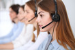 © rogerphoto - Call center. Beautiful cheerful smiling operator consulting clients with headset. Business concept of customer service