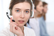 © rogerphoto - Call center. Beautiful cheerful smiling operator consulting clients with headset. Business concept of customer service