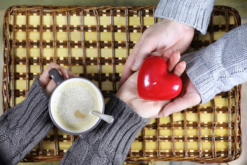 Wall Mural - man presents girl drinks coffee gift on Valentine's Day