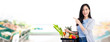 © Atstock Productions - Woman with shopping basket full of groceries in supermarket banner background