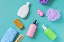 Organic Bath Products/ Shampoo, Brown Soap, Shower Gel, Sponge, Wooden Comb And Rubber Toy Hippo. Flat Lay Baby Cosmetics
