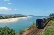 A passenger train passes along the famous Hai Van Pass, in lush coastal Vietnam on a beautiful, sunny day