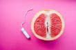 © Svetlana - tampon and grapefruit on a pink background. Concept Vagina symbol and menstruation