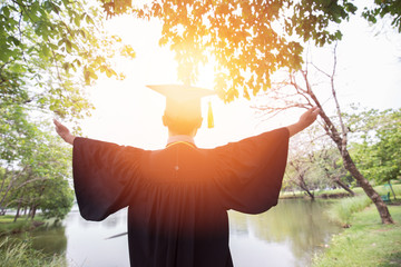 Back of view Graduate put hands up and celebrating and hug the nature feeling so proud and happiness in Commencement day with warm light,Education Success concept