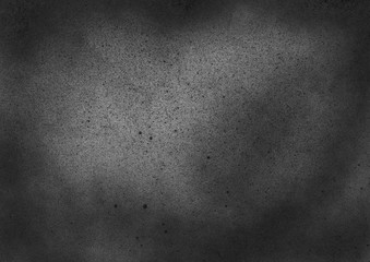 Subtle grain texture. Abstract black and white gritty grunge background. Dark paint spray particles on paper