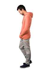 full body of man in a pink sweatshirt standing and looking down on isolated white background. ideal 