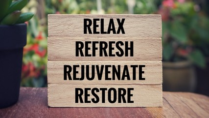 Wall Mural - Motivational and inspirational quote - ‘Relax, refresh, rejuvenate, restore’ written on wooden blocks. Blurred vintage styled background.