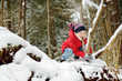 © MNStudio - Adorable little girl having fun in beautiful winter forest. Happy child playing in a snow.