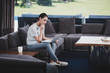 © LIGHTFIELD STUDIOS - side view female freelancer working with laptop on sofa at home