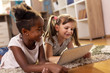 © Impact Photography - Little girls playing video games on a tablet computer