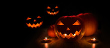 Halloween And Holidays Concept - Many Spooky Carved Pumpkin Jack-o-lanterns With Candles In Darkness