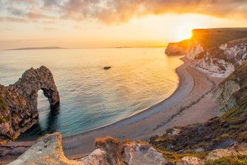 Landscape of empty Durdle Door beach at Sunset. Dorset England.