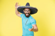 © be free - Mexican party concept. Man cheerful happy face in sombrero hat celebrating yellow background. Guy with beard looks festive in sombrero. Party and holiday concept. Mexican traditional attribute