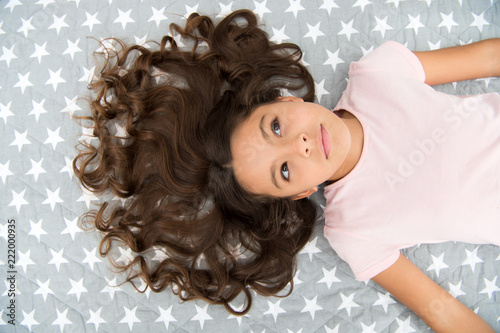 Girl Child With Long Curly Hair Lay On Bed Top View Child Perfect