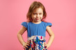 © Ilshat - Horizontal isolated shot of four year old girl in beautiful blue dress on pink background.