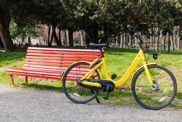 Yellow bike and red bench