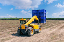 Forklift Loader Loads Plastic Containers.