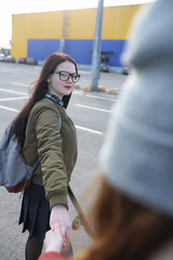 A young hipster girl is riding a skateboard. Girls girlfriends f